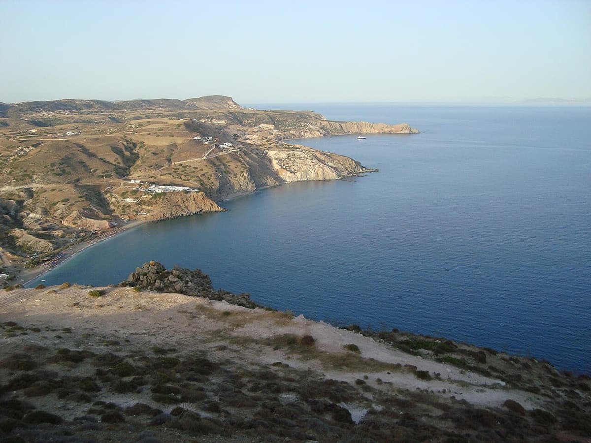 Best time to visit Milos: a calm blue sea along the south coast, with dry hills and a long bay