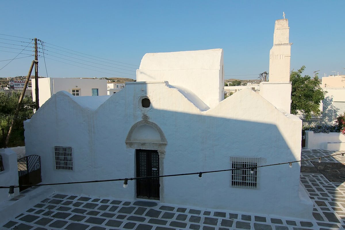 Church museum of Milos: the whitewashed church of the Holy Trinity in Adamantas with its three gables, carved marble doorway and bell tower