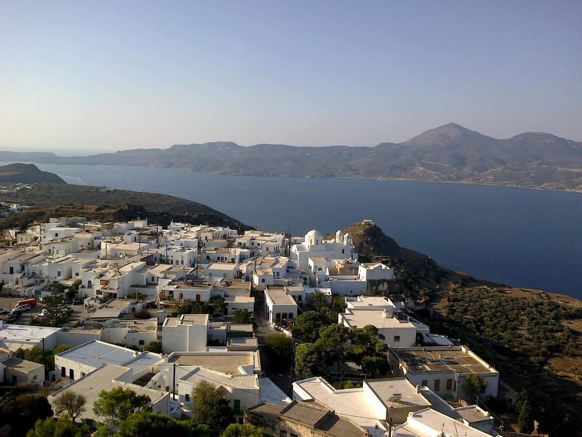 Coffee and drinks in Tripiti: the white houses of Tripiti on the ridge above the gulf of Milos, seen from the Kastro of Plaka