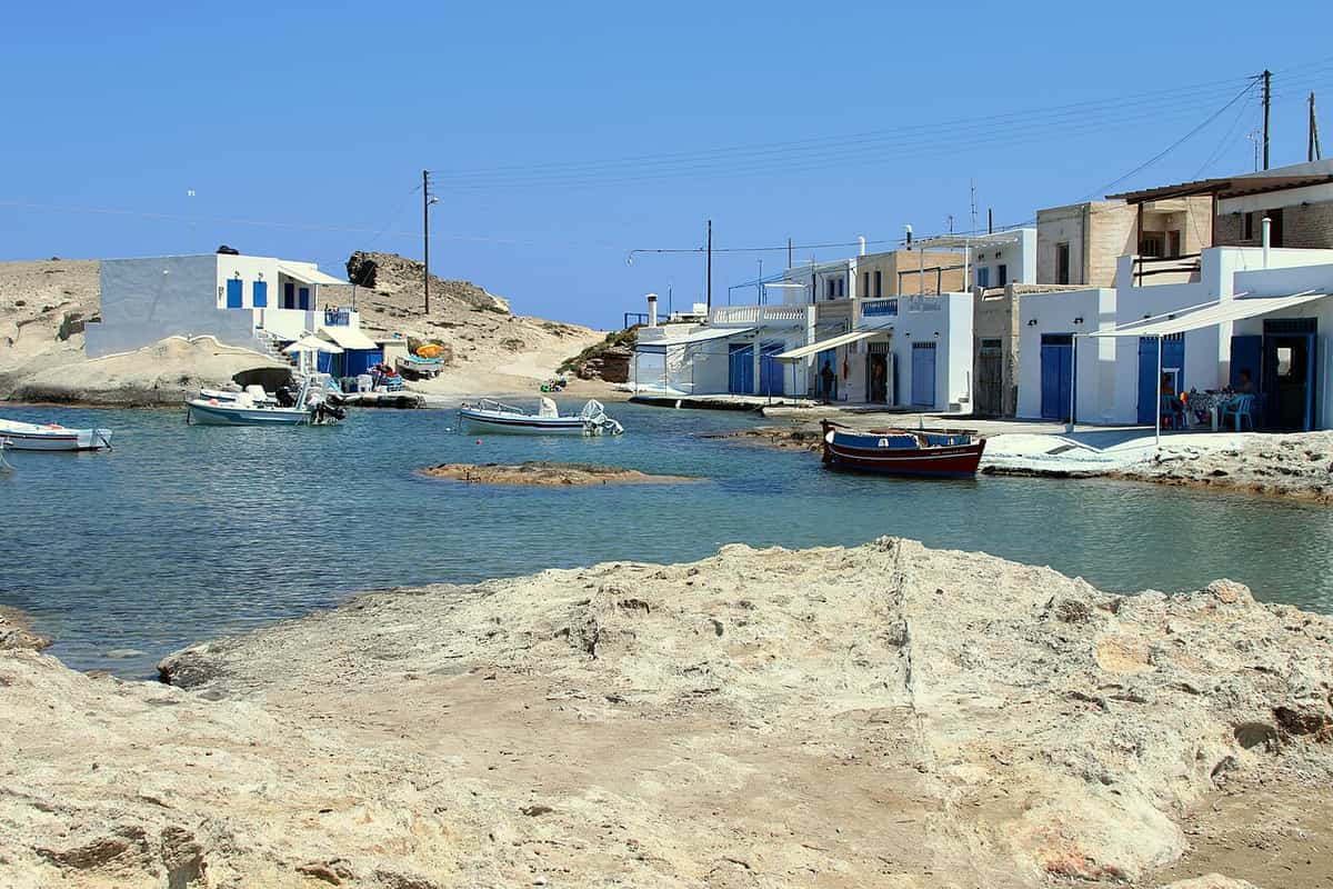 Fishing village of Milos: boathouses with blue doors and small boats at Agios Konstantinos, near Pachena
