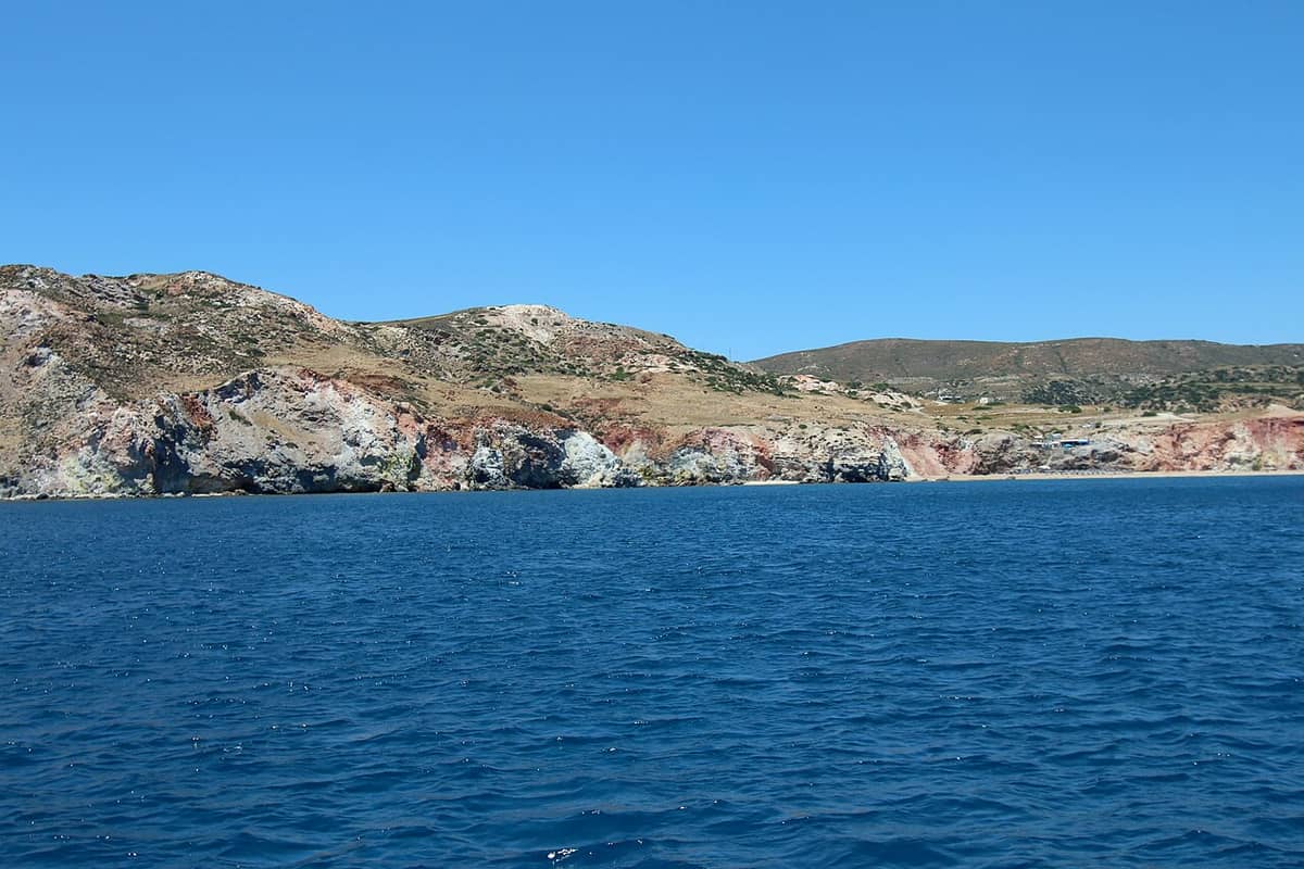 Food in Paleochori: the coloured cliffs and the beach of Paleochori on the south coast of Milos, seen from the sea