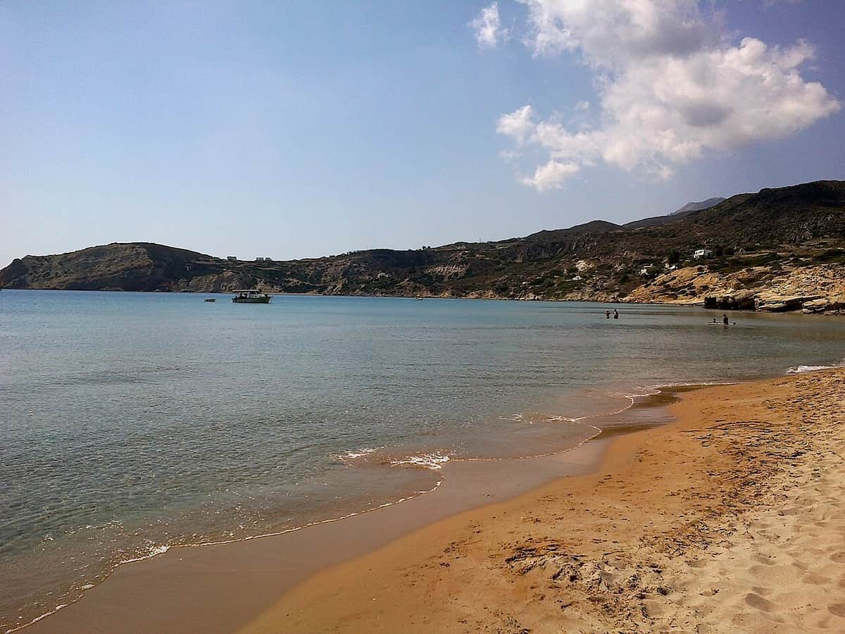 Food in Provatas: the long sandy beach of Provatas with shallow clear water and the hills of south Milos