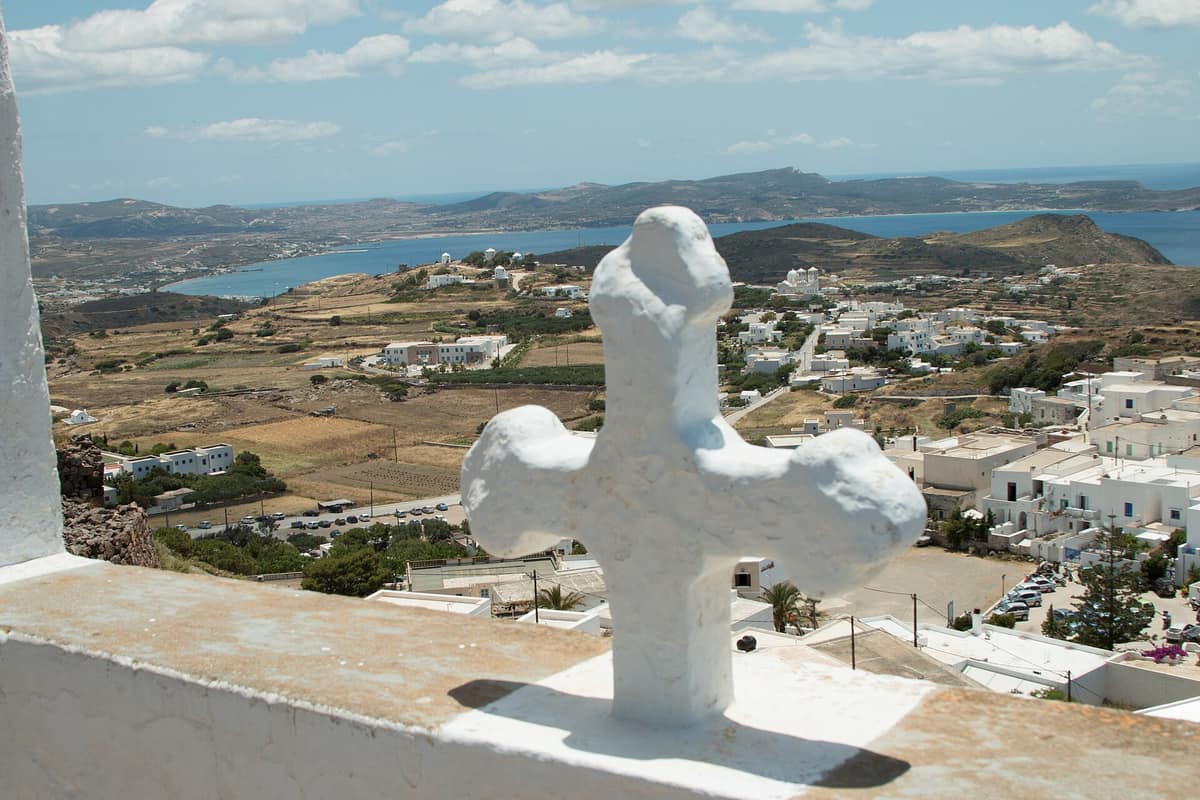 Food in Triovasalos: the white houses of Triovasalos and the farmland of central Milos below the Kastro, with the gulf in the distance