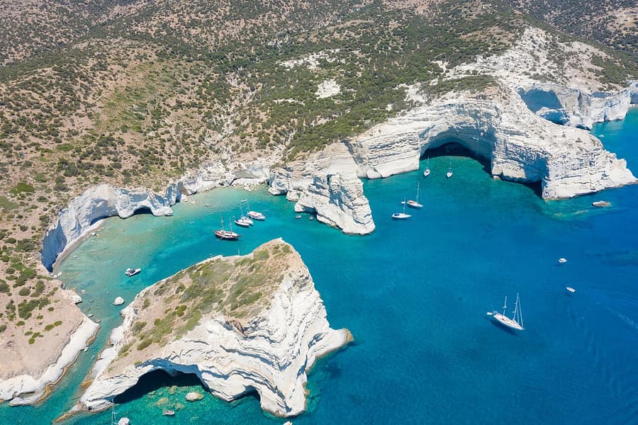 Gerontas beach coast: white volcanic cliffs, arches and sea caves in turquoise water on the south-west coast of Milos