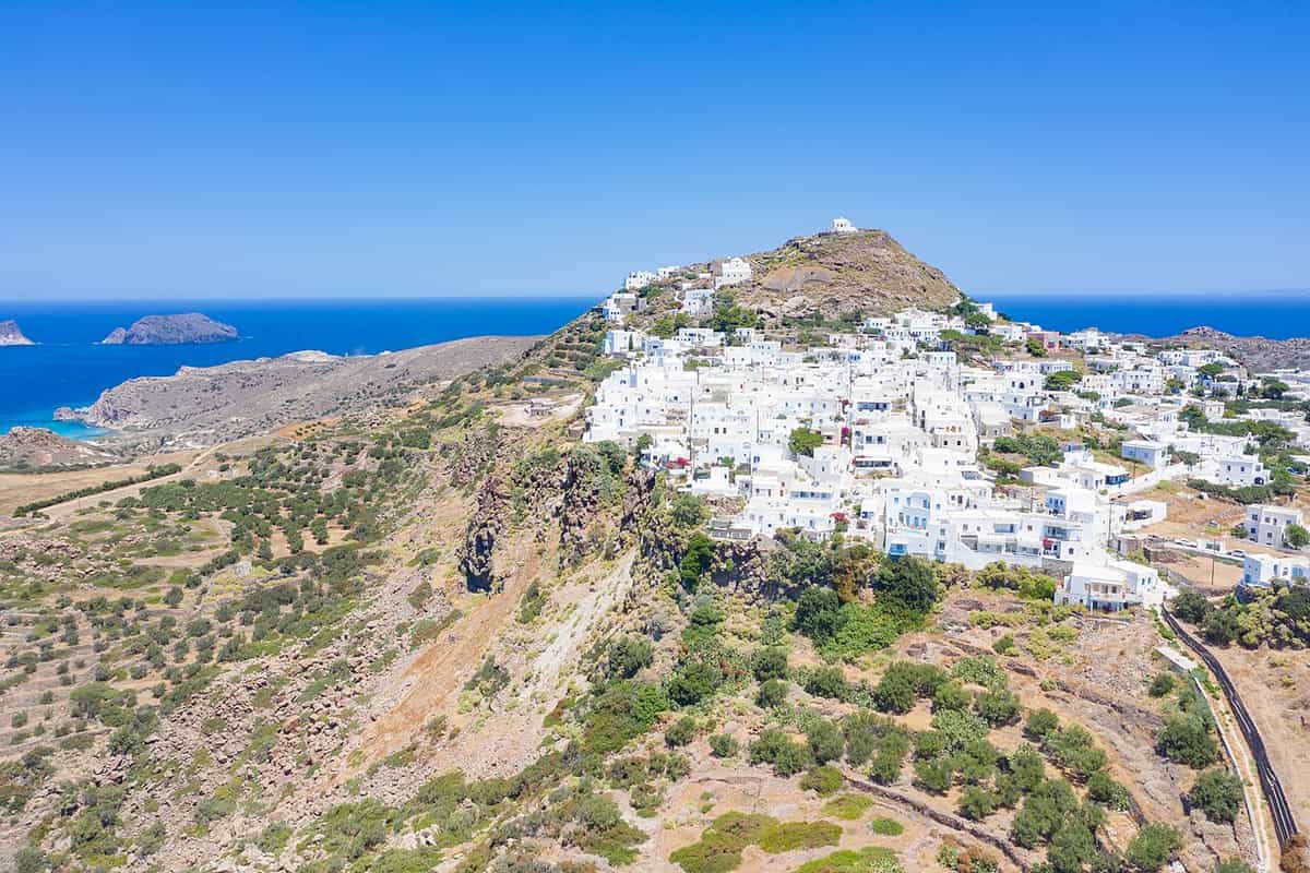 Milos: the white houses of Plaka on the hillside below the Kastro hill, with the Aegean Sea behind