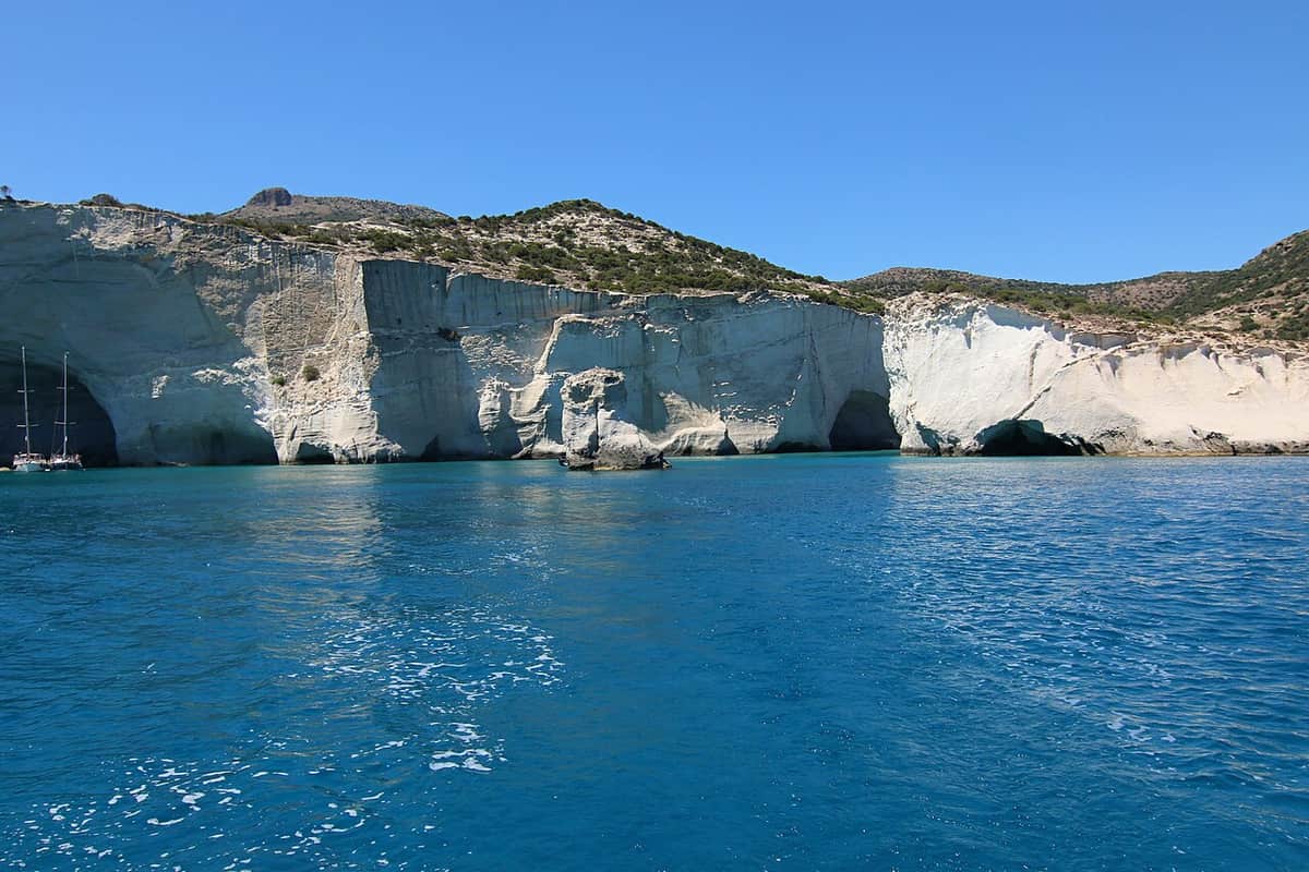 Kayak in Milos: white volcanic cliffs with sea caves and arches at Kleftiko above deep blue water