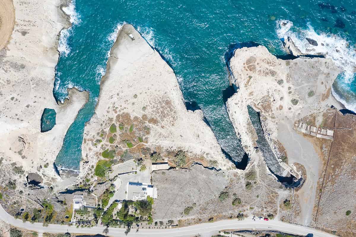 Kayak Papafragas: the narrow sea inlets of Papafragas cut into pale rock on the north-east coast of Milos, seen from above