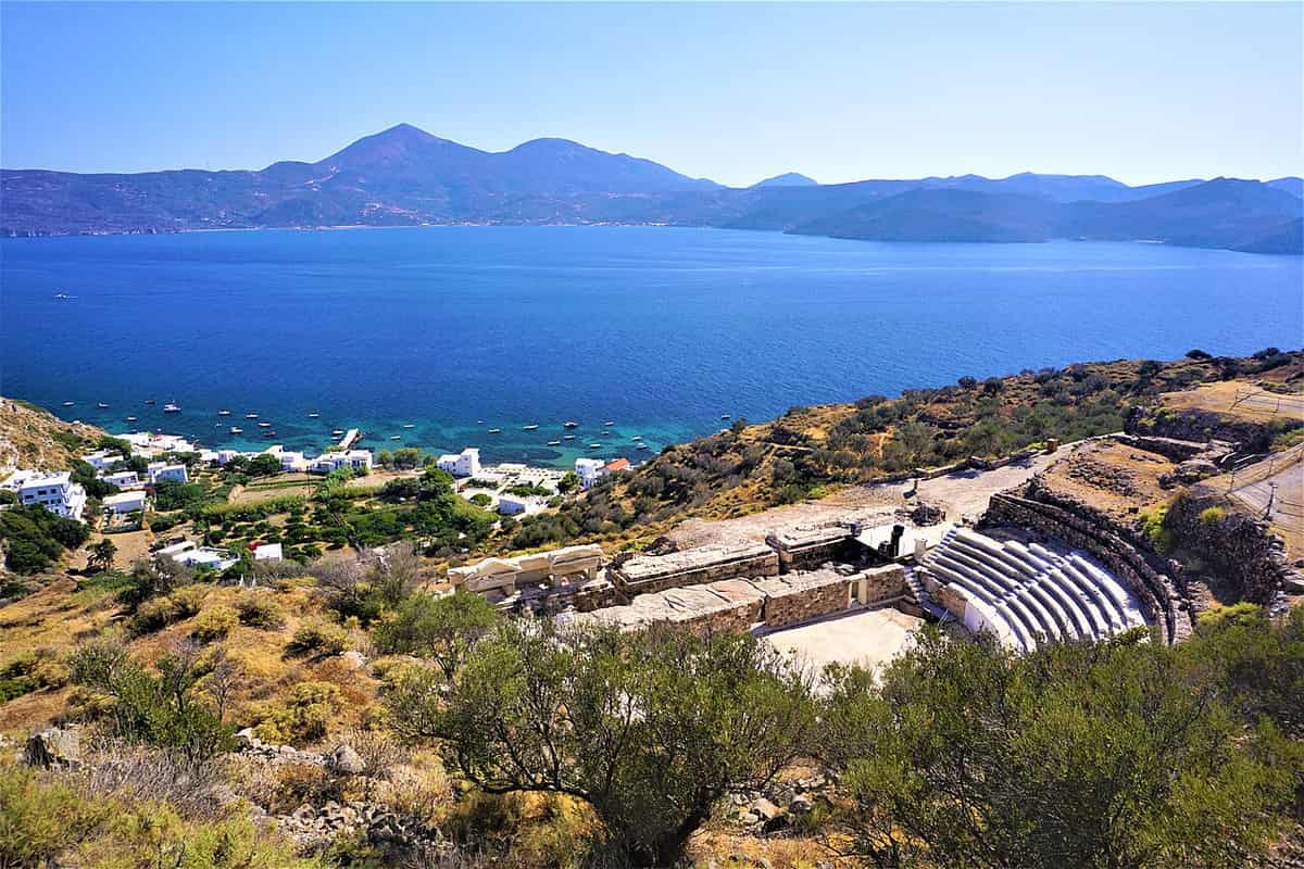 Milos sights: the marble seats of the ancient theatre above Klima, with the bay of Milos and the western hills behind