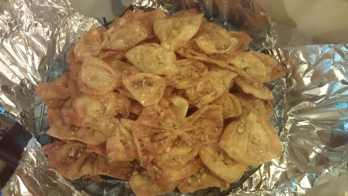 Sweets in Provatas: home-made diples, thin folded pastries fried and covered in honey, piled on a tray