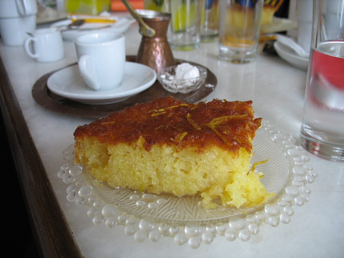 Sweets in Provatas: a slice of revani, the Greek semolina cake soaked in syrup with lemon zest, beside a Greek coffee
