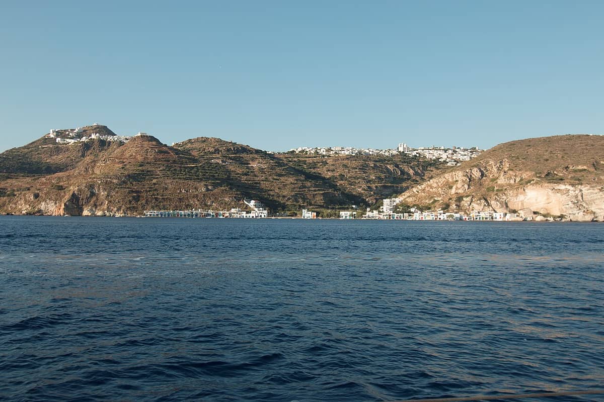Sweets in Tripiti: the white houses of Plaka and Tripiti on the ridge above Klima, seen from the gulf of Milos