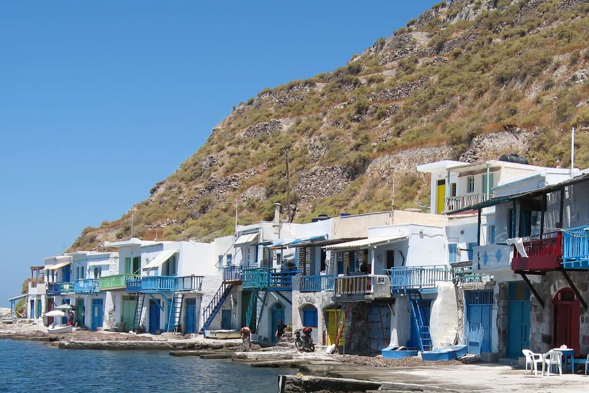 Colourful syrmata boat houses along the water at Klima, a fishing village on Milos