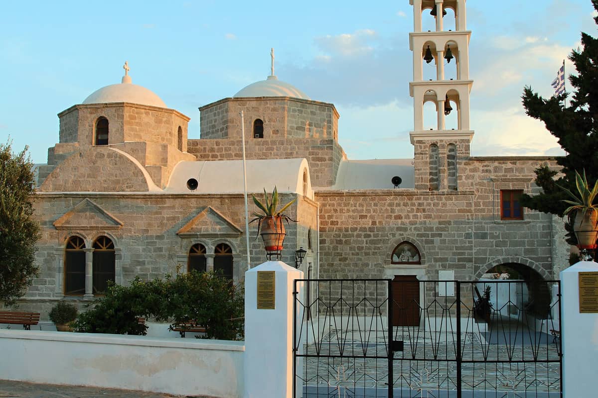 Zefiria: the stone church of Panagia Portiani with its domes and tall bell tower in the old capital of Milos