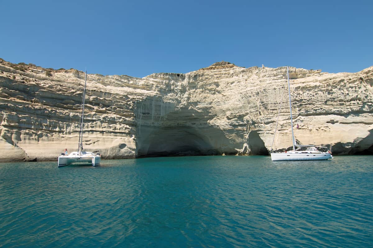 kayak Κλέφτικο: θαλάσσια σπηλιά κάτω από τους λευκούς βράχους του Κλέφτικου με δύο σκάφη στα γαλάζια νερά