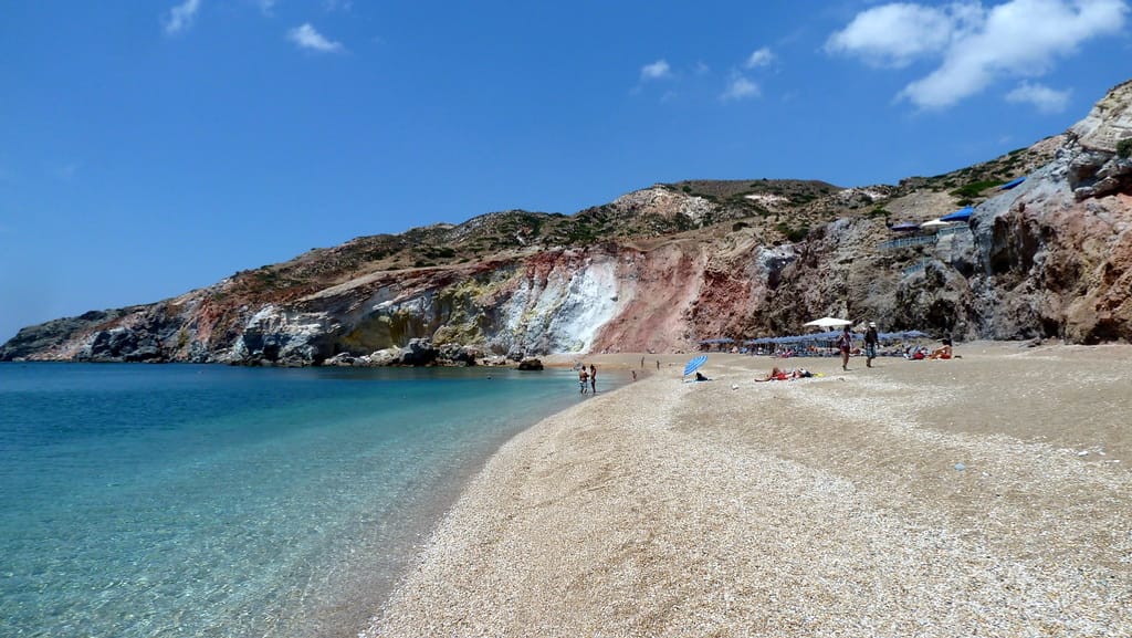 Nude beach Milos: Paleochori beach with clear water, light pebbles and colourful volcanic cliffs